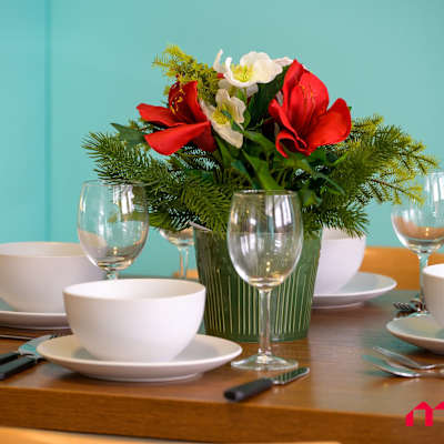 Close-up of the dining table setting with floral arrangement and tableware.