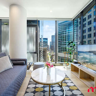 Alternate living area angle showing sofa (sofa bed) and balcony access.