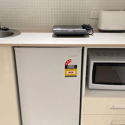 Additional kitchenette angle showing microwave, cabinetry, and storage space.