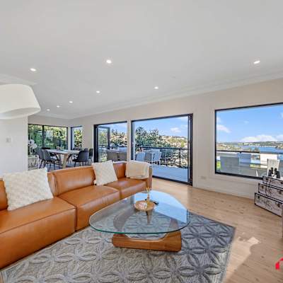 Main living area with leather sofa seating and expansive water views.