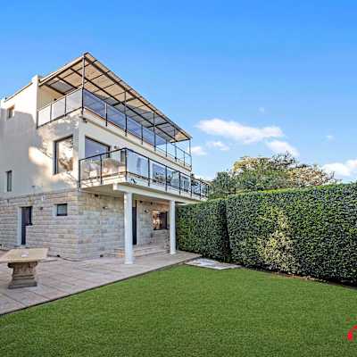Rear exterior view with lawn area and multi-level structure.