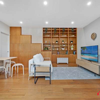 Open-plan living and dining space with lounge seating and TV area.