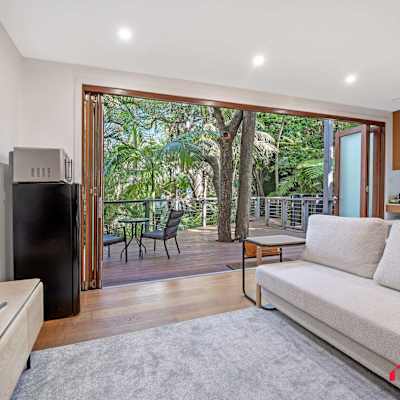 Living room with sofa, TV, and large sliding doors opening to the balcony.