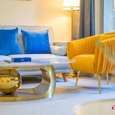 Living room with comfortable seating and a sofa bed, coffee table, and stylish accent chairs.
