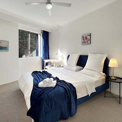 Bedroom featuring a king-size bed, bedside tables, and lamps.