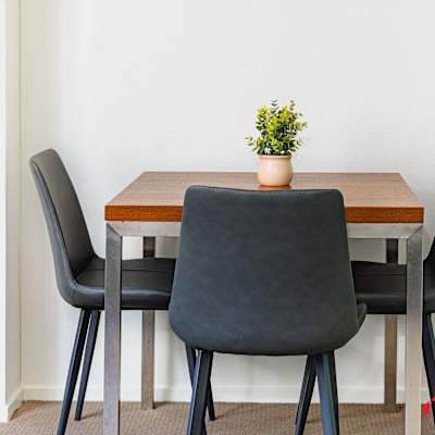 Small dining setting with table and chairs.