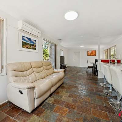 Common living and dining area with cream sofa and open-plan layout.