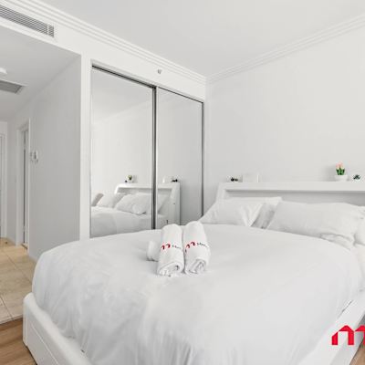 Cozy bedroom with mirrored wardrobe