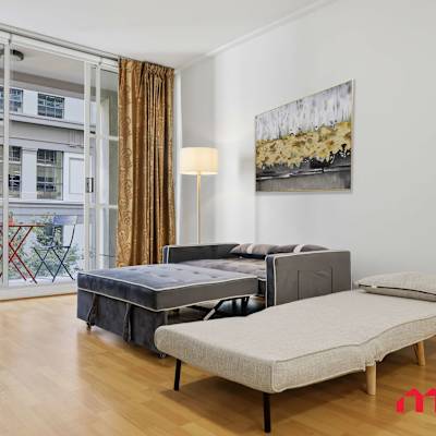 Open living space with sofa and bed