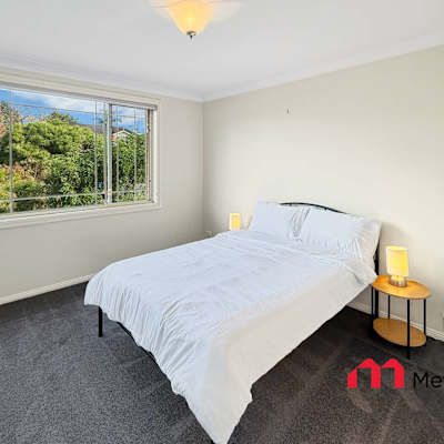 Sunny bedroom overlooking greenery