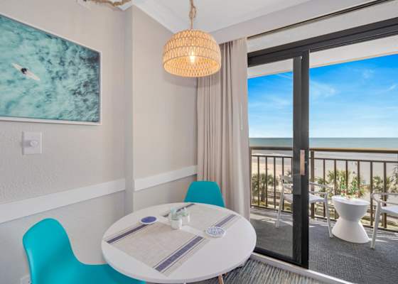 Cozy dining area with ocean views, perfect for enjoying meals with a breathtaking backdrop. Relax and unwind in this bright, inviting space!
