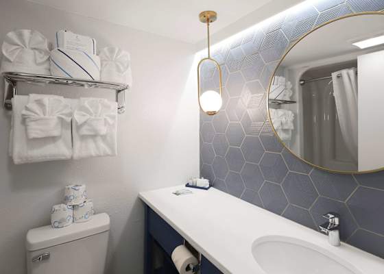 Fresh, clean, and thoughtfully stocked, this bathroom offers plush towels, a spacious vanity, and a tub-shower combo—everything you need to refresh after a day of sun, sand, and seaside fun.