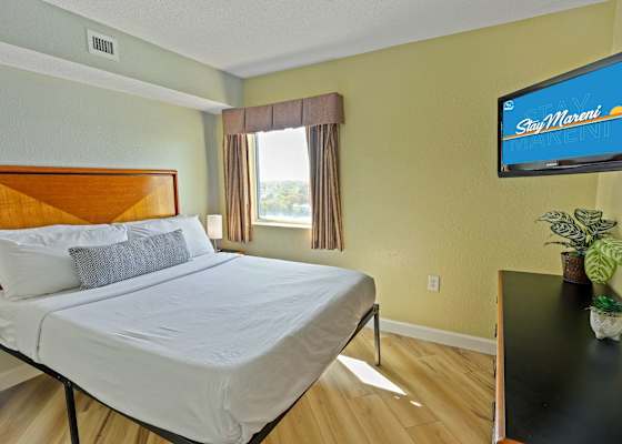 Sink into a plush Queen bed dressed in premium linens and enjoy the perfect blend of comfort and relaxation. With abundant natural light, serene views, and a thoughtfully designed space, this inviting bedroom is your retreat after a day at the beach!