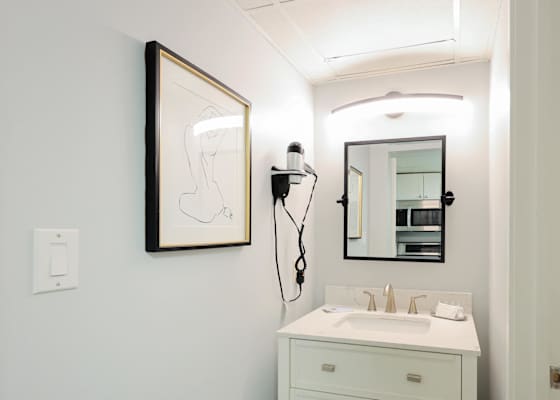 Get ready in style with this modern vanity space, complete with a well-lit mirror, sleek design, and built-in hairdryer. A clean and functional bathroom setup to keep you feeling refreshed during your Myrtle Beach stay!
