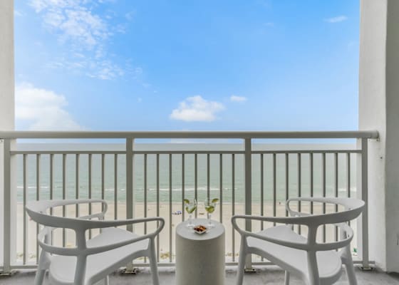 Sip your favorite drink while soaking in breathtaking ocean views from this private balcony. With cozy seating and serene beach vibes, it's the perfect spot to relax and enjoy the coastal breeze.