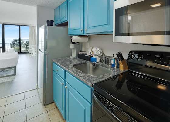 Enjoy the convenience of a full kitchen with everything you need to cook up your favorites. With ocean views just steps away, this space makes dining in as delightful as heading out. Perfect for extended stays or cozy beachside meals.