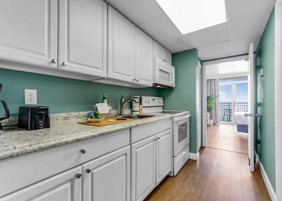 Whip up delicious meals in this fully equipped kitchen, featuring modern appliances and a sleek design. With the ocean breeze just steps away, it’s the perfect blend of convenience and coastal charm for your getaway.