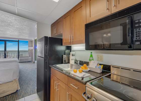 Bright, open kitchen with modern appliances and stunning ocean views. Perfect for cooking up a storm while enjoying the coastal breeze. 
