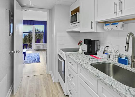Whip up breakfast with an ocean breeze just steps away! This sleek, fully stocked kitchen has everything you need—and the view from the doorway? Just icing on the cake. 