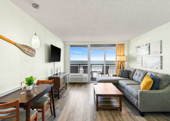 Coastal charm meets comfort in this breezy beachfront living room—sip wine, soak in the view, and unwind in style just steps from the shore. Your seaside sanctuary awaits.