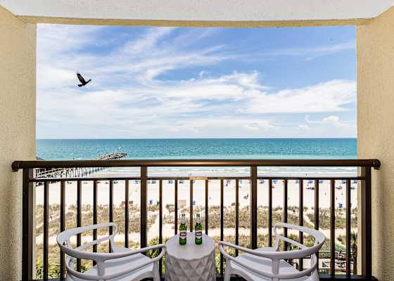 Enjoy stunning ocean views from your private balcony, complete with cozy seating to relax and take in the sights of the beach. Perfect for morning coffee or sunset evenings!