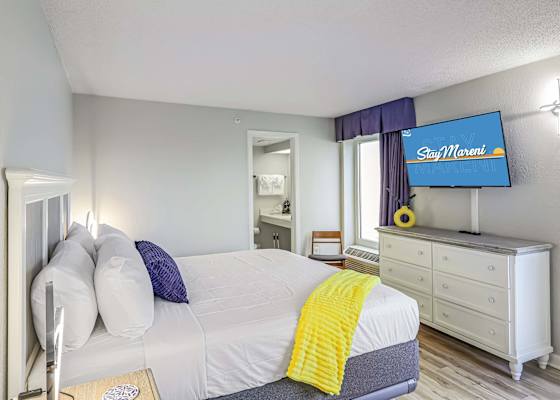 Wake up in style with cozy coastal vibes, pops of color, and your own private ensuite. Comfy king bed, flat-screen TV, and natural light make this the ultimate recharge zone after a day on the beach!