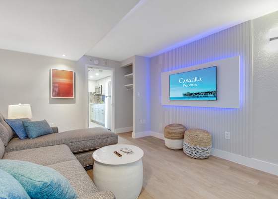 Relax in this cozy, living area featuring a plush sectional, accent lighting, and a Smart TV for entertainment. The soothing decor and comfortable seating make it an ideal spot to unwind after a day of exploring.