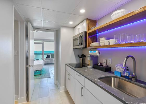 Wake up to ocean views and brew your favorite coffee in this sleek kitchenette—fully stocked and steps from the beach. The perfect blend of comfort, convenience, and coastal charm for your next seaside escape!