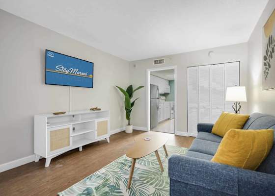 Unwind in this chic and cozy living room, featuring stylish décor, a plush sofa, and a smart TV for your entertainment. The perfect spot to relax after a day of beachside adventures.