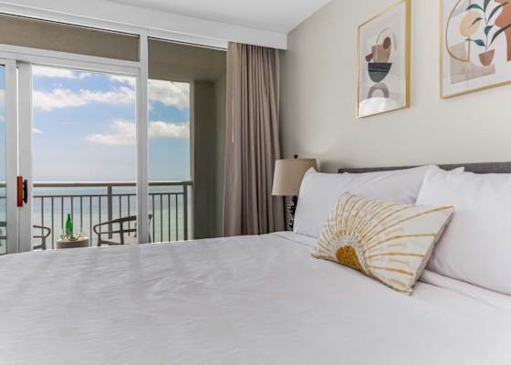 Wake up to breathtaking ocean views from this serene bedroom. Featuring a plush king bed, cozy decor, and direct balcony access, this space invites you to relax and soak in the coastal charm.