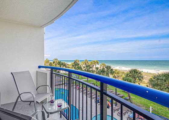 Step out onto your private balcony and soak in panoramic ocean views. With comfortable seating and a side table perfect for snacks or drinks, this serene spot invites you to unwind and enjoy the gentle sea breeze and the calming sound of the waves.