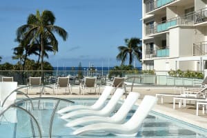 Outdoor pool deck with chairs and open sky