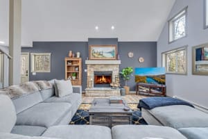 Relax by the warmth of the wood-burning fireplace, unwind on the spacious couch, and enjoy your favorite show on the large TV. Perfect for a cozy night in.