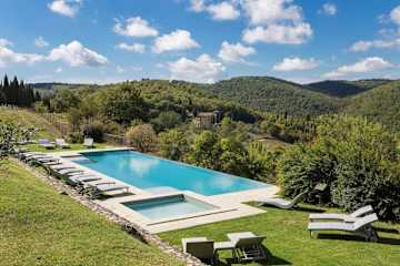 Infinity swimming pool with view over a wooded valley