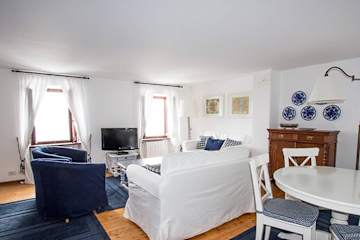 Navy blue and white sofas and dining table