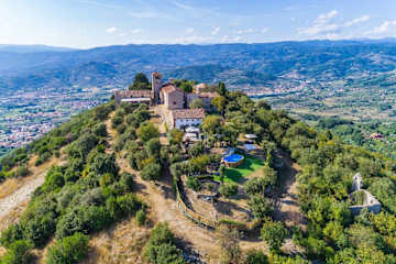 Aerial view of a hilltop villa with pool