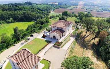 Aerial view of a white villa with tiled roof