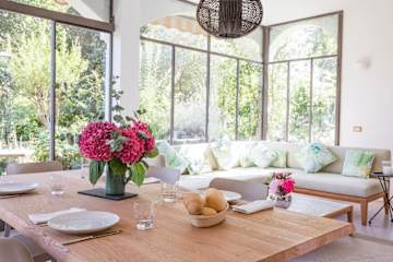 Pink hydrangeas on a wooden dining table