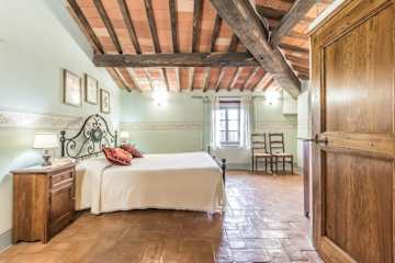 Bedroom with metal bed and original tiled floors