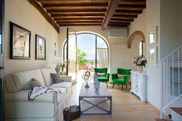 Living room with cream sofa and two green chairs