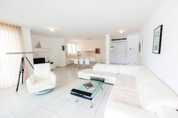 Living room with cream sofas and tiled floor