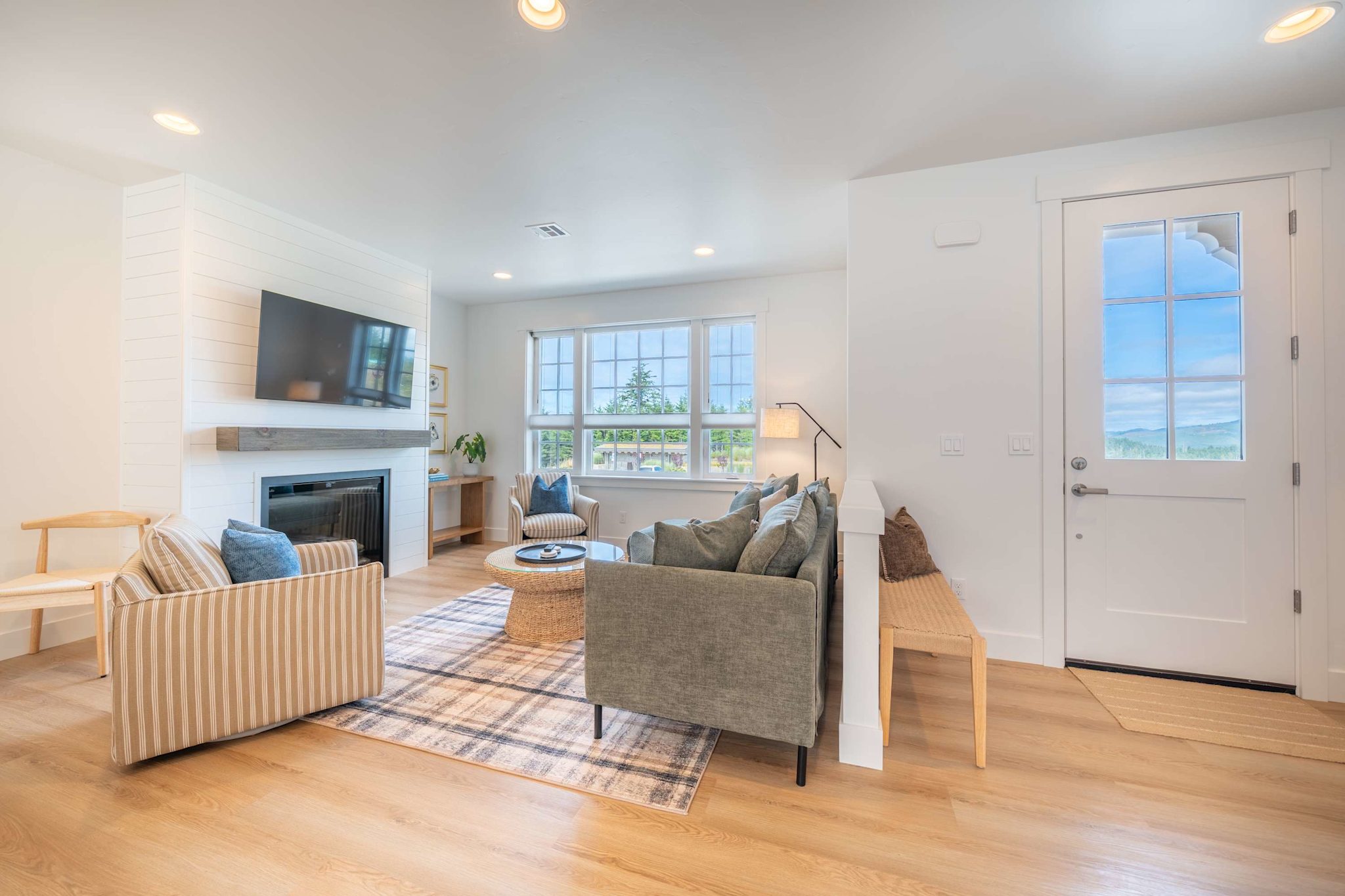 Bright living room with fireplace, smart TV, and comfortable seating