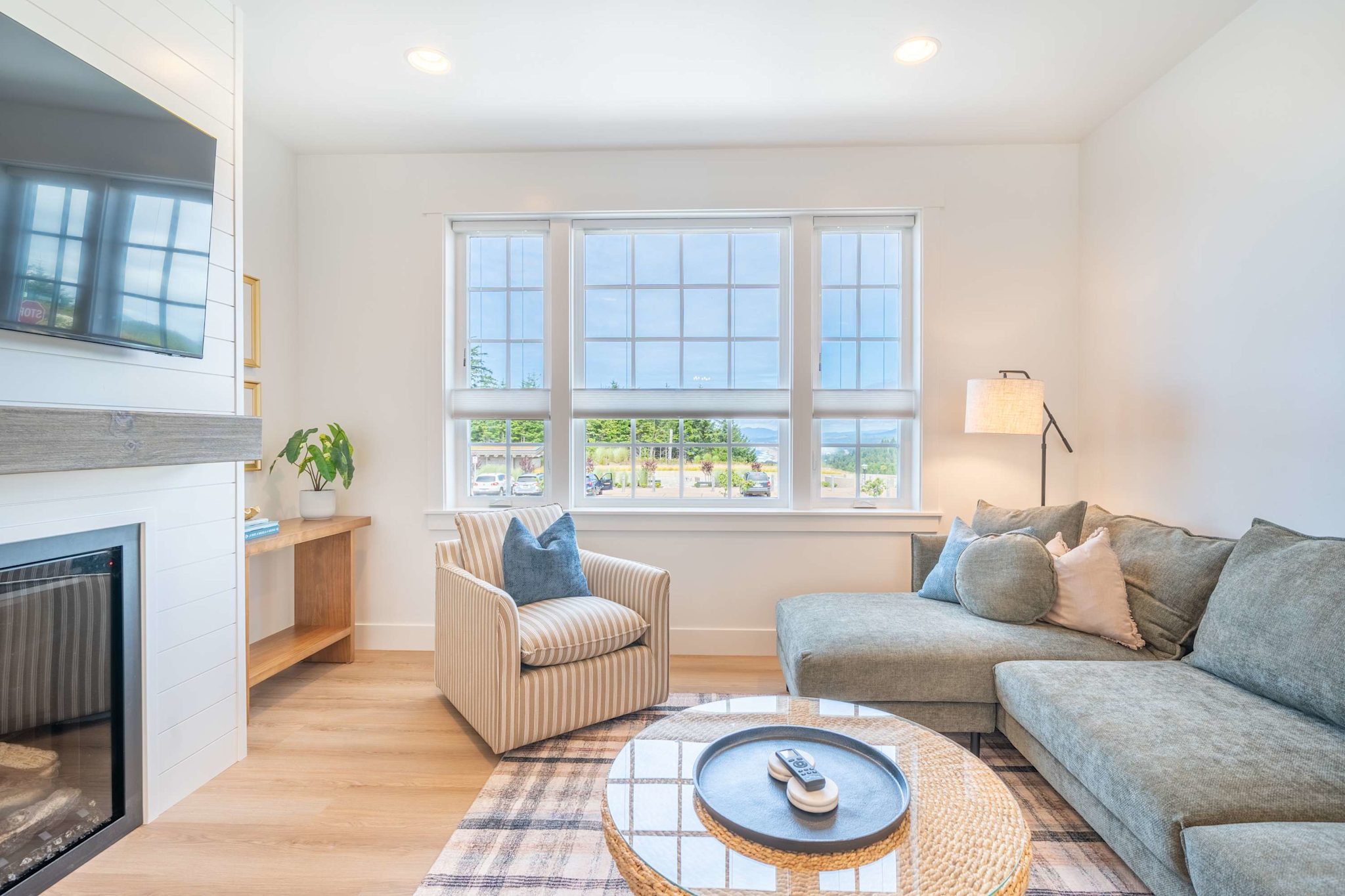 Cozy living room seating beside the fireplace and smart TV
