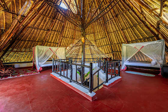 Two beds share the open upstairs loft around the stairwell; this is not an enclosed bedroom.