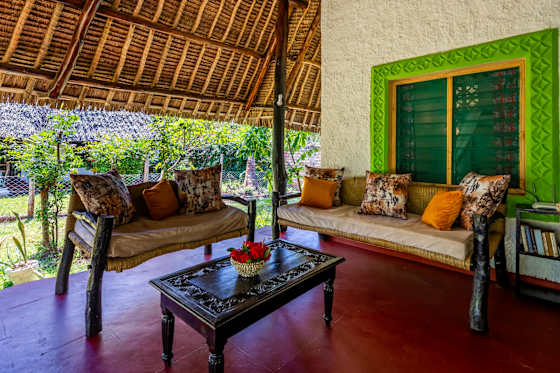 Relax on the covered veranda, with cushioned sofas and a coffee table.