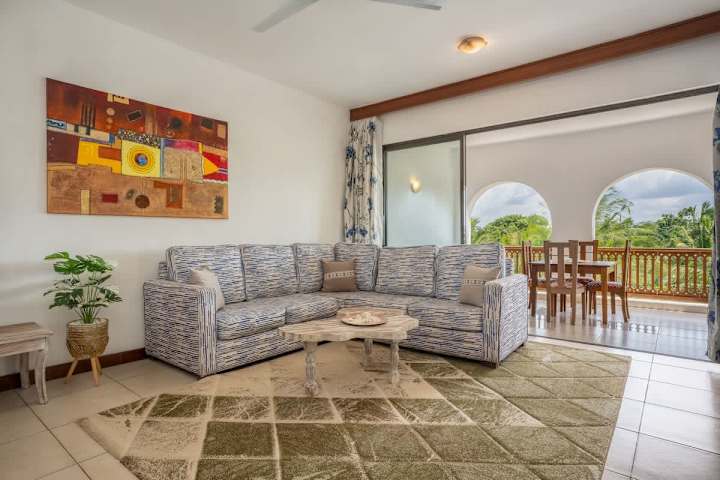 Tulia’s bright living room opens onto an arched balcony with leafy views.