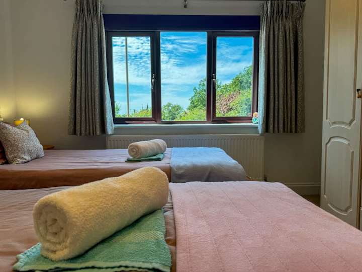 Perfect for sharing or solo comfort, this bedroom features two cozy single beds for a restful retreat.