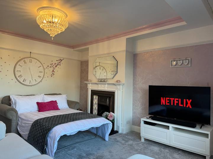 Comfy sofa bed in the lounge with 55" TV.