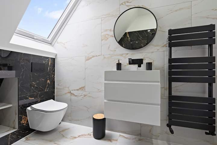 A modern bathroom with a skylight , bathtub, shower and plenty of space.