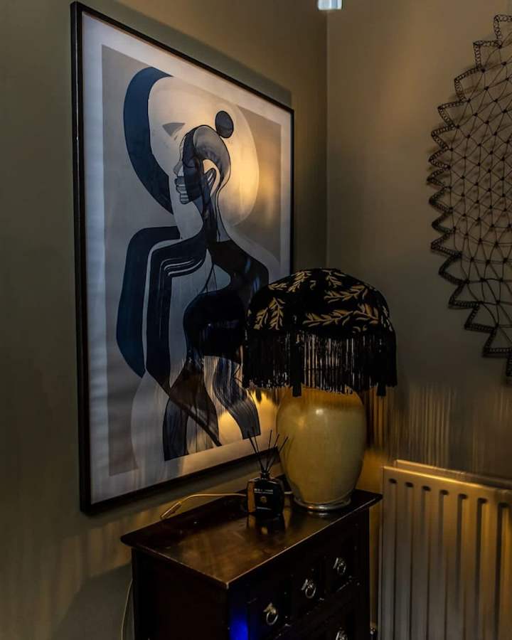 Stylish lamp and wall decor to enhance the room's charm.